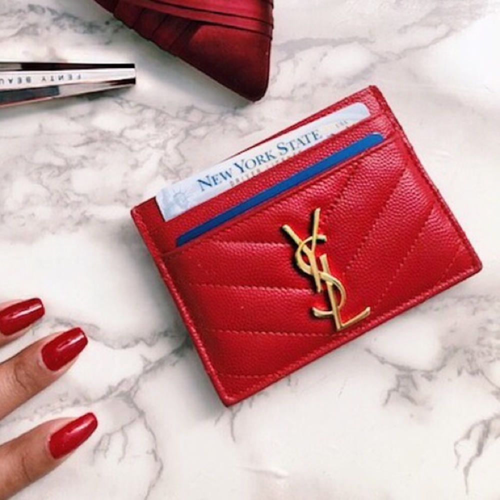 Red leather YSL card holder with gold detail.
